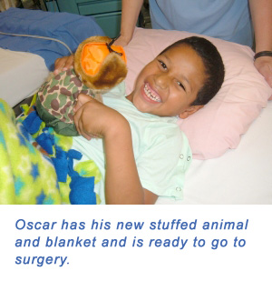 Oscar has is new stuffed animal and blanket and is ready to go to surgery.